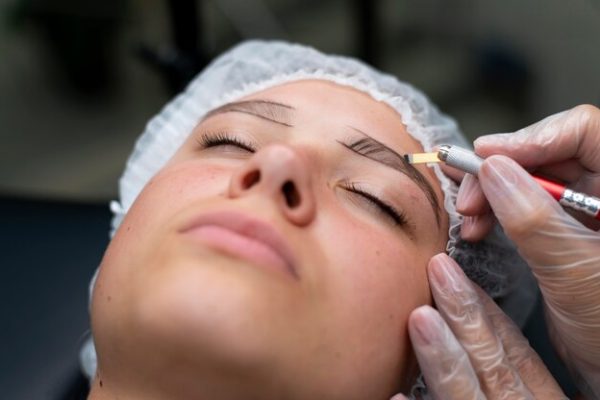 beautician-doing-microblading-procedure-woman-beauty-salon_23-2149102715